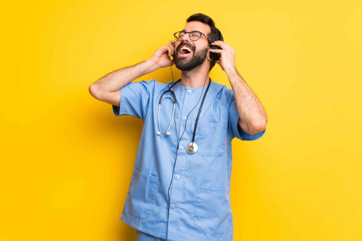 Surgeon doctor man listening to music with headphones Here’s What Music Surgeons Are Listening To In The Operating Room